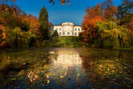 the Czartoryski Palace among trees and mirrored in water